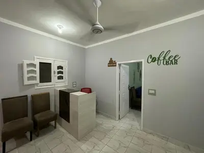 a room with two chairs and a desk with a sign on the wall at Skylen Hostel in Hurghada