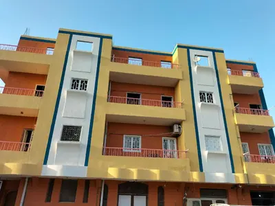 a tall building with orange and yellow at Skylen Hostel in Hurghada