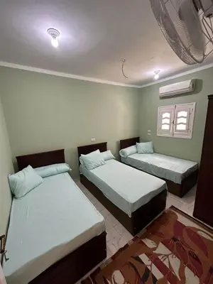 a bedroom with two beds and a window at Skylen Hostel in Hurghada
