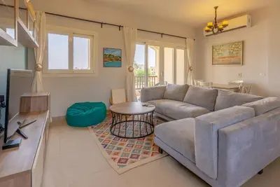 a living room with a couch and a table at Peaceful 2-Bedroom in Waterside, El Gouna. Pool & Lagoon in Hurghada