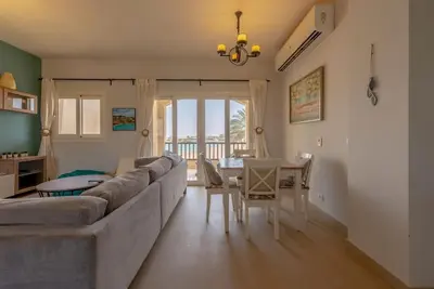 a living room with a couch and a table at Peaceful 2-Bedroom in Waterside, El Gouna. Pool & Lagoon in Hurghada