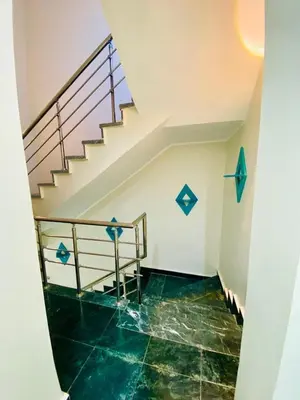 a room with a staircase and green tile floor at Hurghada-Magawish Villa 1 in Hurghada