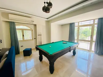 a living room with a pool table in it at Hurghada-Magawish Villa 1 in Hurghada