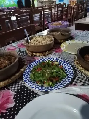 a table with a plate of food and a bowl of food at WestLuxApartment in Al Karnak