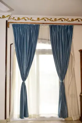 a window with blue curtains in a room at Flamingo Boutique hotels in Luxor