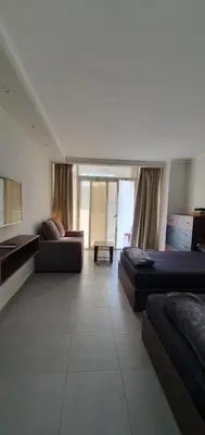 a large room with two beds and a couch at Scandic Cinde in Hurghada