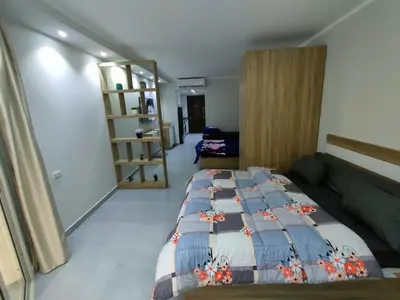a bedroom with a bed with a quilt on it at Scandic Cinde in Hurghada