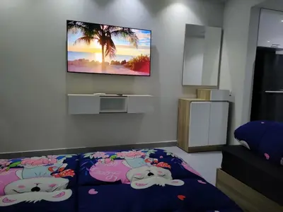 a bedroom with a tv hanging on a wall at Scandic Cinde in Hurghada