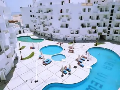 an aerial view of a building with two pools at منتجع طيبة فيو Tiba view in Hurghada