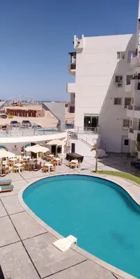 a swimming pool in front of a building at منتجع طيبة فيو Tiba view in Hurghada