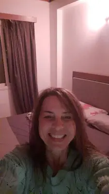 a woman is smiling for the camera in a bedroom at Hurghada Makadi Heights in Hurghada