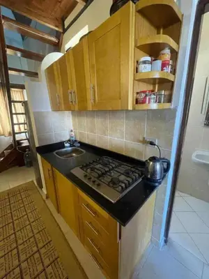 a small kitchen with a stove and a sink at Hurghada Makadi Heights in Hurghada