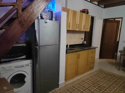 a kitchen with a refrigerator and a washing machine at Hurghada Makadi Heights in Hurghada