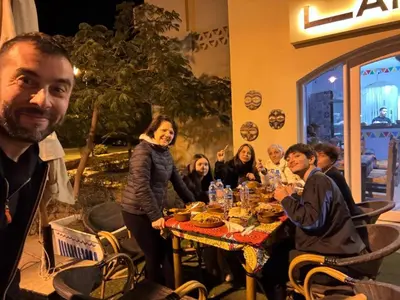 a group of people sitting around a table in a restaurant at Hurghada Makadi Heights in Hurghada
