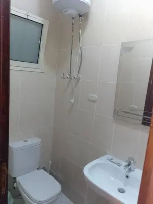a bathroom with a toilet and a sink at Hurghada Makadi Heights in Hurghada