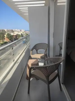 three chairs and a table on a balcony with a view at Scandic Resort - Mido Chalet in Hurghada