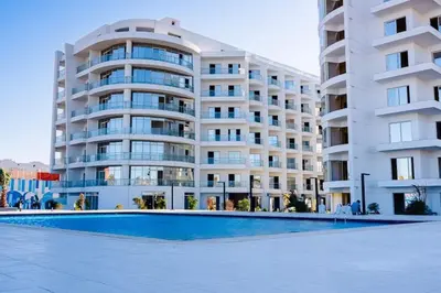 a large apartment building with a swimming pool in front of it at Scandic Resort - Mido Chalet in Hurghada