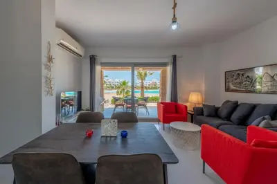 a living room with a couch and a table at New! Lovely 1BR in Swan Lake, Gouna. Azure Lagoon in Hurghada