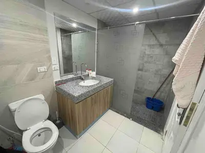 a bathroom with a toilet and a sink with a mirror at شاليه السعادة in Hurghada