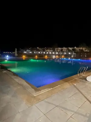 a view of a swimming pool at night at شاليه السعادة in Hurghada