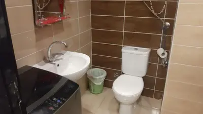 a small bathroom with a toilet and a sink at casa di nonna in Hurghada