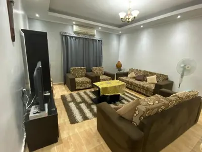 a living room with a couch and a tv at Amwaj Compound in Hurghada