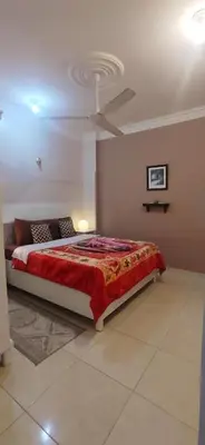 a bedroom with a large bed with a red blanket at Villa Rebecca in Luxor