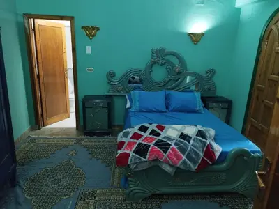a blue bedroom with a bed with blue walls at Gabawy Garden Ferienwohnung in Luxor