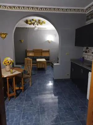 a kitchen and dining room with an archway and a table at Gabawy Garden Ferienwohnung in Luxor
