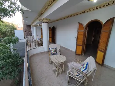 a patio with chairs and a table and a table and chairs at Gabawy Garden Ferienwohnung in Luxor