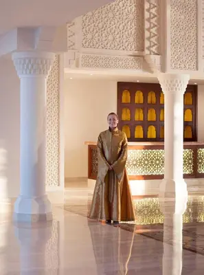 a man standing in a room with columns at Baron Palace Sahl Hasheesh in Hurghada