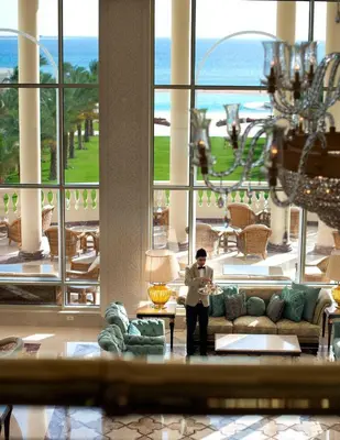 a man standing in the lobby of a hotel at Baron Palace Sahl Hasheesh in Hurghada