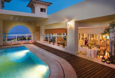 a villa with a swimming pool and a dining area at Baron Palace Sahl Hasheesh in Hurghada
