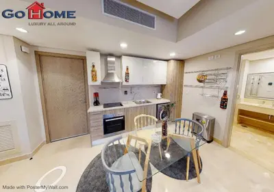 a kitchen with a glass table and chairs in it at Stylish 1BR-Pool View M7-6B at Mangroovy El-Gouna in Hurghada