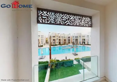 a view of a swimming pool from a window at Stylish 1BR-Pool View M7-6B at Mangroovy El-Gouna in Hurghada