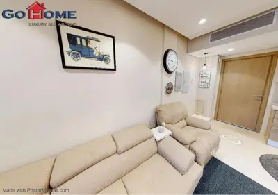 a living room with a couch and a clock on the wall at Stylish 1BR-Pool View M7-6B at Mangroovy El-Gouna in Hurghada