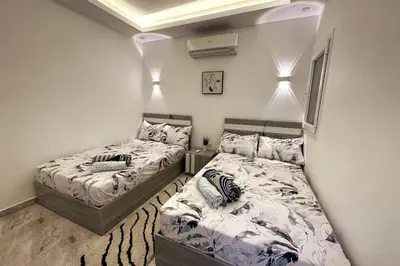 two beds in a small room with two beds sidx sidx sidx sidx at 2 Bed Flat - Sleeps 6 - Pool - Parking - Wifi in Hurghada