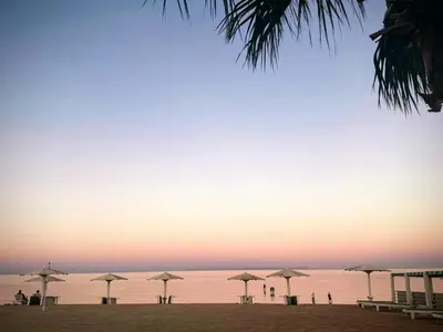 a group of umbrellas on a beach at sunset at 2 Bed Flat - Sleeps 6 - Pool - Parking - Wifi in Hurghada