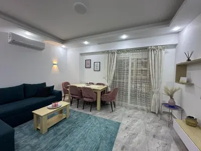 a living room with a couch and a table at 2 Bed Flat - Sleeps 6 - Pool - Parking - Wifi in Hurghada