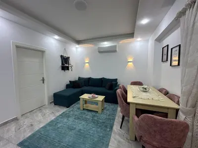 a living room with a blue couch and a table at 2 Bed Flat - Sleeps 6 - Pool - Parking - Wifi in Hurghada