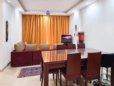 a dining room with a table and a couch at Sea View at Gravity Sahl Hasheesh 7 Pools & Beach-FOR GUESTS WITH NONEGYPTIAN PASSPORTS in Hurghada