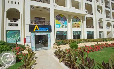 a large building with flowers in front of it at Sea View at Gravity Sahl Hasheesh 7 Pools & Beach-FOR GUESTS WITH NONEGYPTIAN PASSPORTS in Hurghada