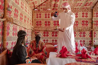 a man taking a picture of two people in a room at Lemon & Soul Makadi Garden in Hurghada