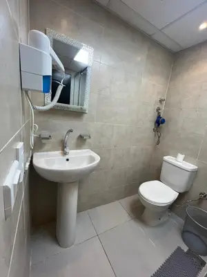 a bathroom with a toilet and a sink at Benashti Hurghada apartment in Hurghada