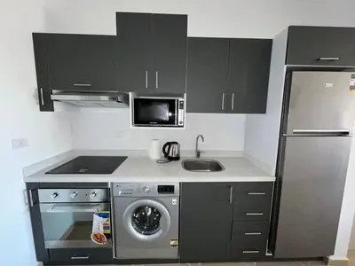 a small kitchen with a sink and a refrigerator at Benashti Hurghada apartment in Hurghada