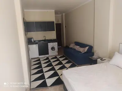 a small room with a bed and a kitchen at Magawish District in Hurghada