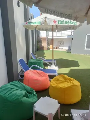 a group of chairs and an umbrella on the floor at Magawish District in Hurghada