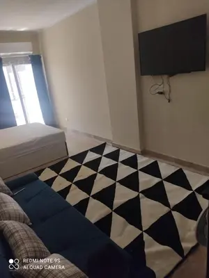 a bedroom with a black and white checkered floor at Magawish District in Hurghada