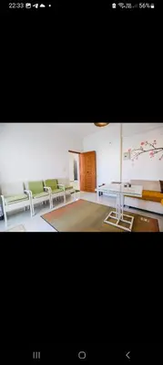a room with green chairs and a table in it at La bonita compound for rent in Hurghada
