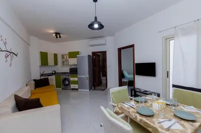 a living room with a couch and a table with chairs at La bonita compound for rent in Hurghada
